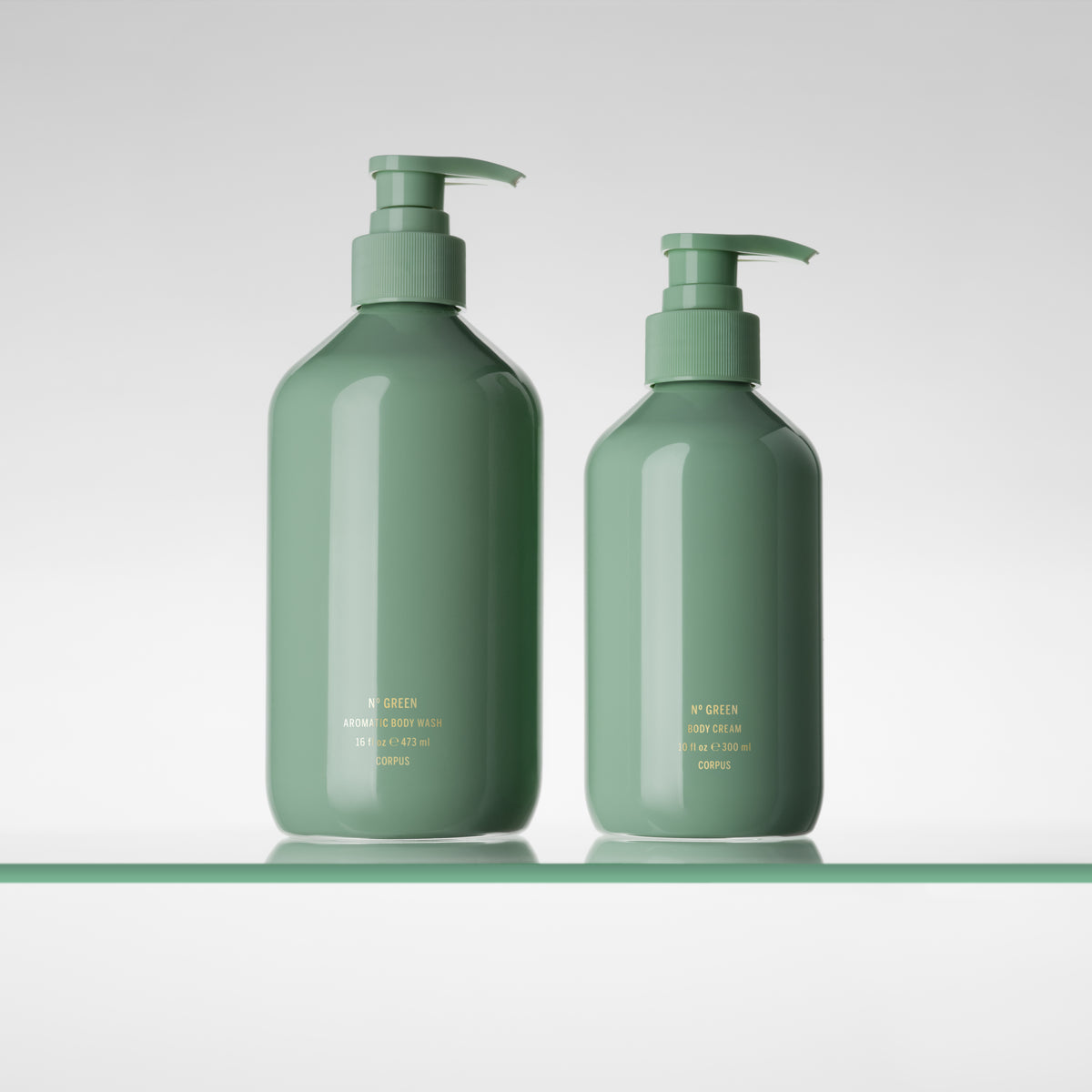 CORPUS Nº Green Aromatic Body Wash and Body Cream pump bottles side by side on a glass shelf